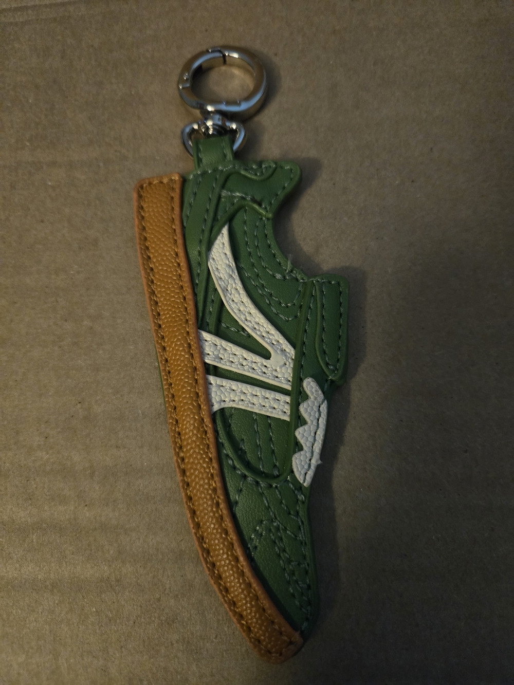 Steve Madden faux leather Color Green Olive   keychain shaped like a sneaker.